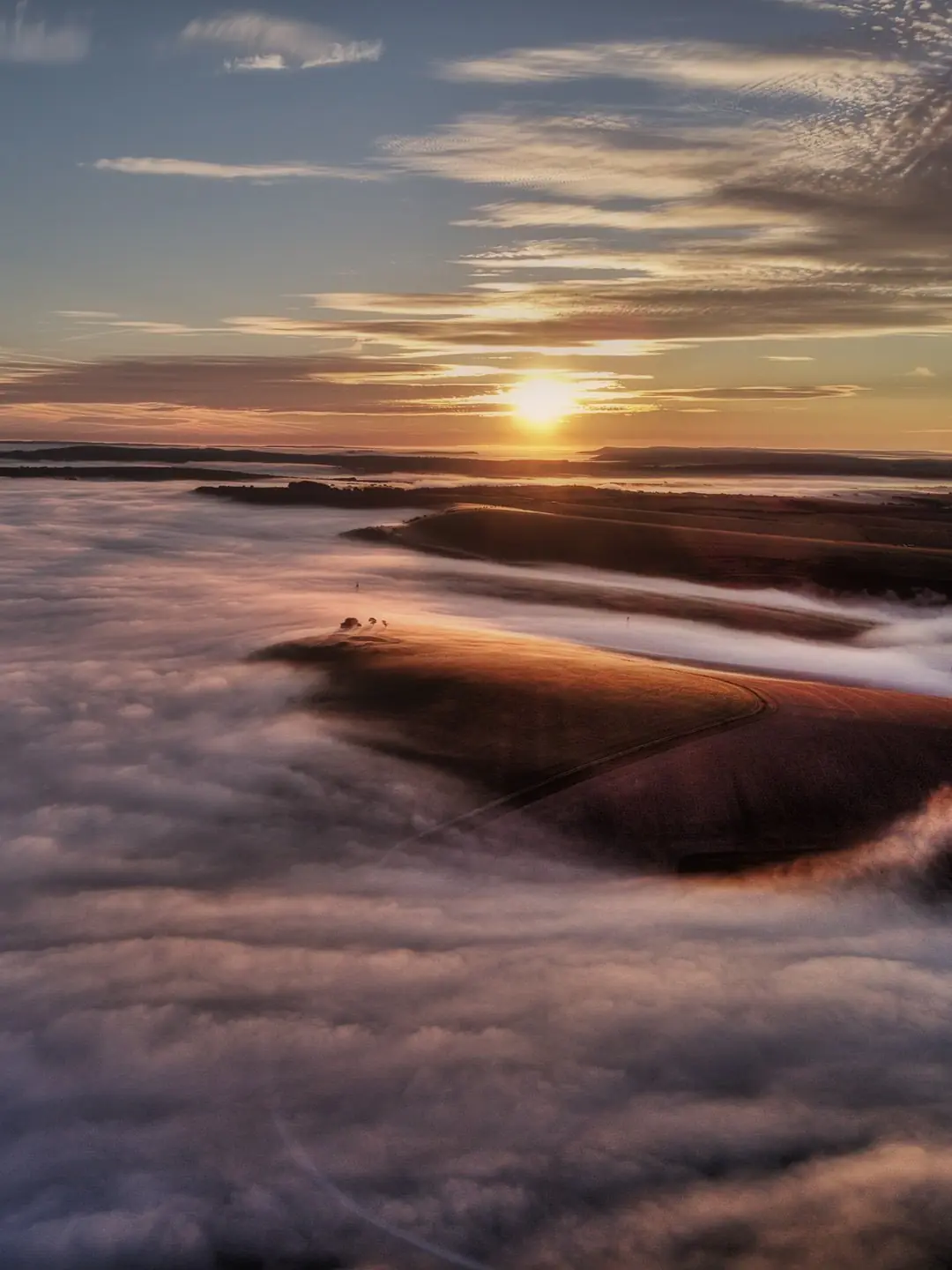 The sun coming up over the Downs and the coast